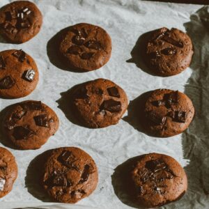 Delicious homemade chocolate chip cookies freshly baked and cooling on a tray.